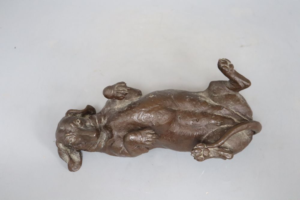 A composite figure of a recumbent dachshund, signed Doris Lindner, length 26cm